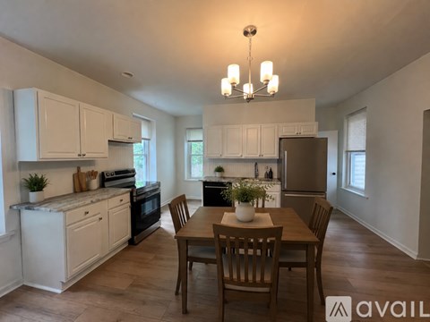 A kitchen with a table and chairs in the middle of the room.