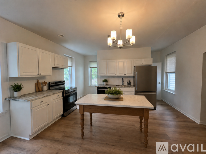 A kitchen with a table and chairs in the middle of the room.