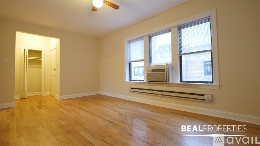A room with a window and a ceiling fan.