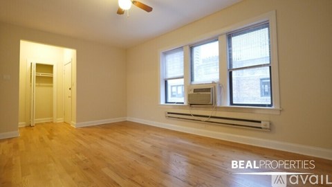 A room with a window and a ceiling fan.