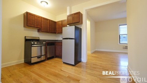 A kitchen with wooden cabinets and a white refrigerator.