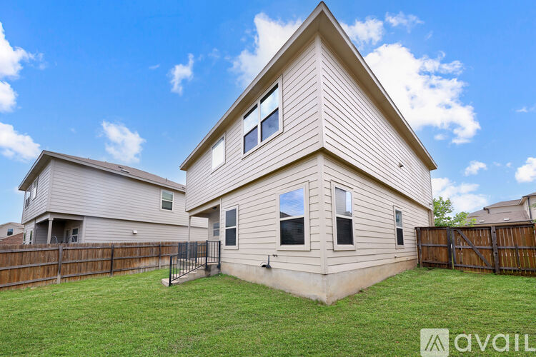 A house with a fence and a grassy yard is for sale.
