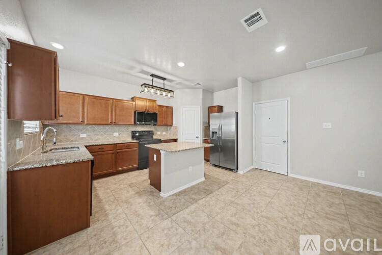 A kitchen with brown cabinets and a white refrigerator.