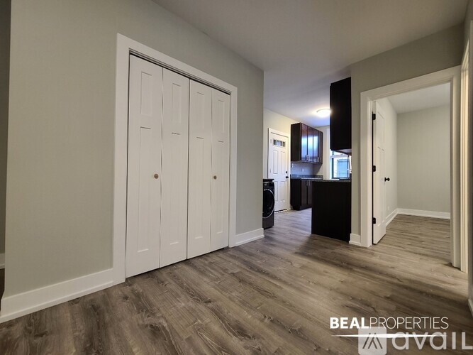 A room with a white door and a black cabinet.