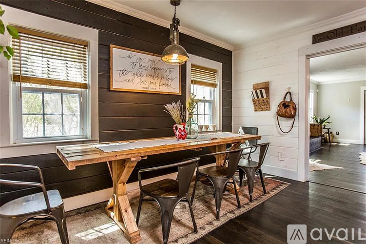 A dining room with a wooden table and chairs.