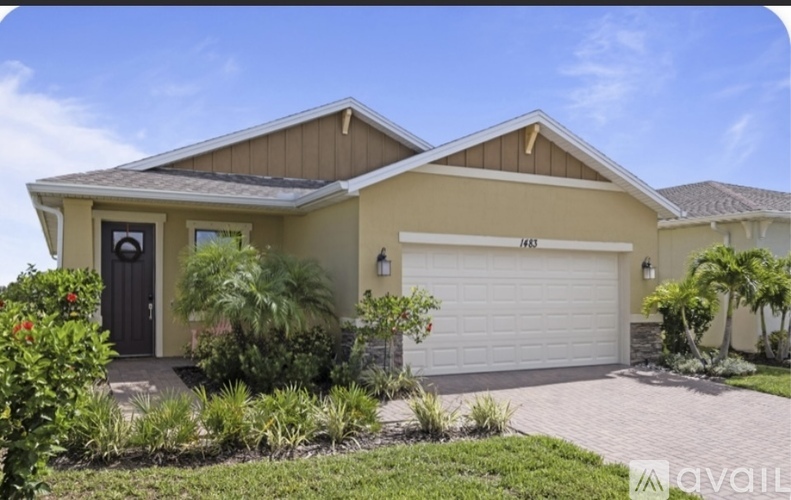 A house with a brown roof and a white garage door is for sale.
