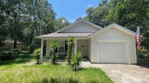 A house with a garage and a flag on the right side.