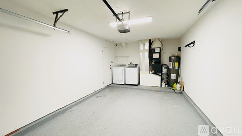 A spacious garage with white walls and a concrete floor.