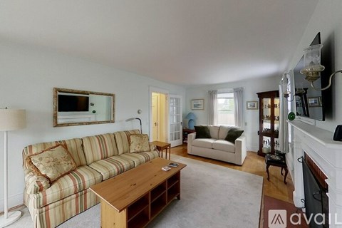A living room with a striped couch and a coffee table.