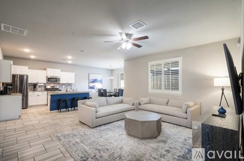 A living room with a white couch and a television.