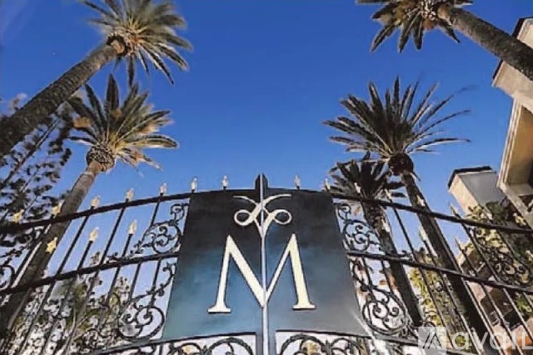 A gate with a large letter M on it.
