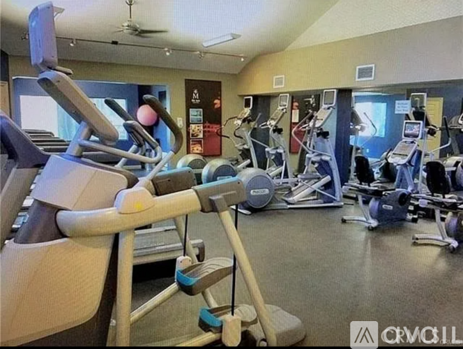 A gym with various exercise machines and equipment.
