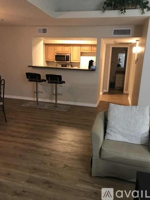 A living room with a couch and a bar area.