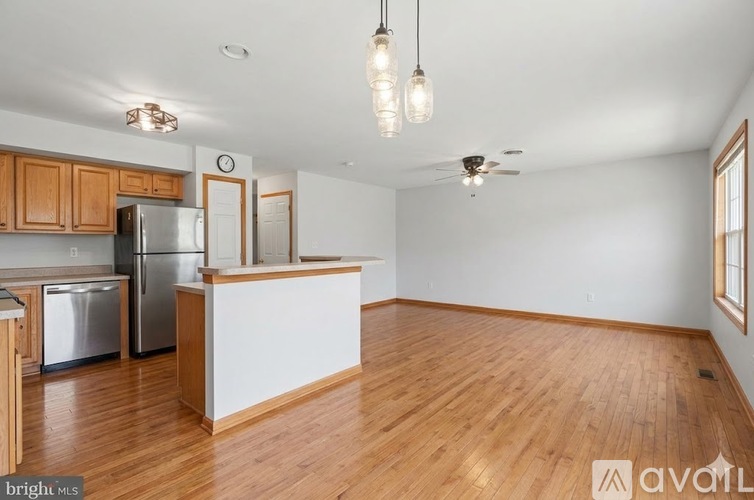 A kitchen with wooden cabinets and a white countertop.