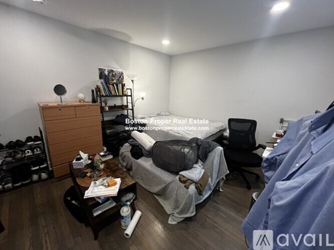 A living room with a grey couch and a wooden side table.