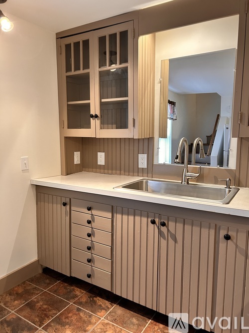 A bathroom with a sink and a mirror.