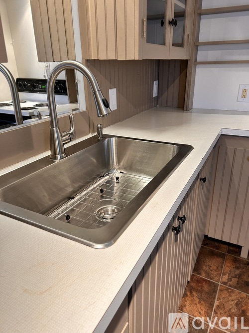 A kitchen sink with a faucet and a countertop.
