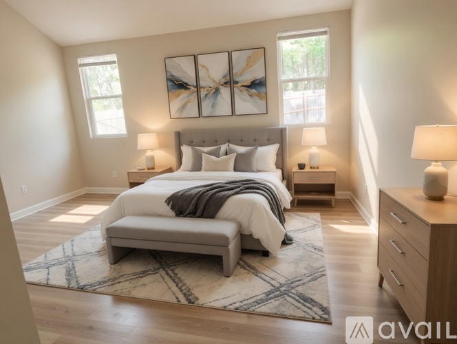 A bedroom with a large bed and a painting on the wall.