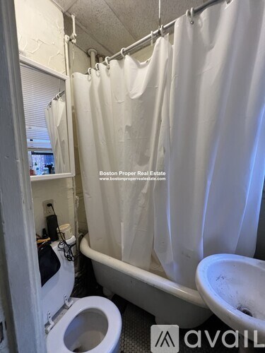 A bathroom with a toilet, a sink, and a bathtub.