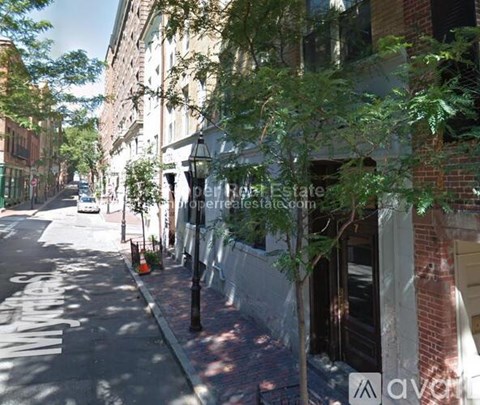 A street view with a white car parked on the side of the road.