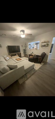 A living room with a television and a couch.