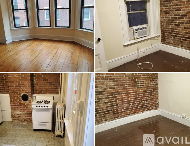A room with a brick wall and a white stove.