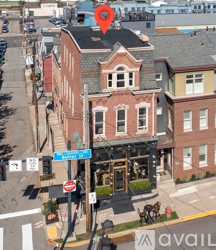 A street view of a building with a sign that says Butler St.