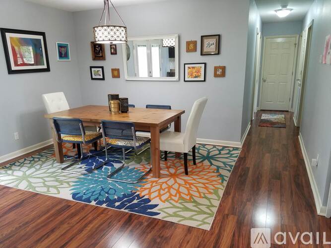 A dining room with a wooden table and chairs.