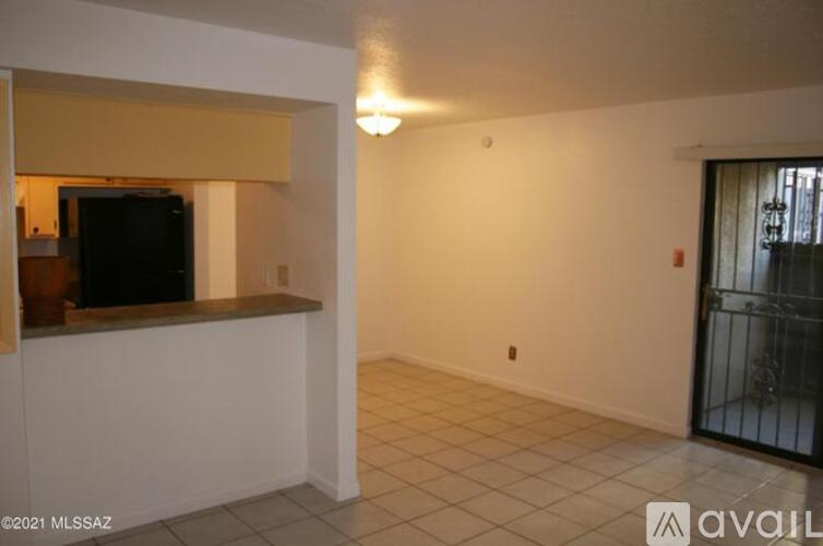 A room with a television on a counter and a sliding glass door.