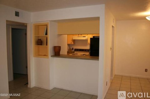 A kitchen area with a counter and a cabinet.
