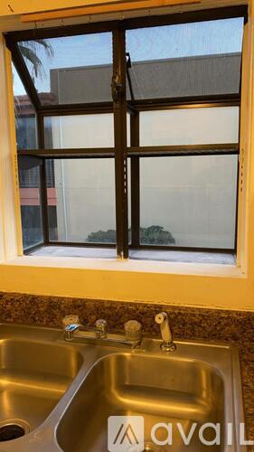 A kitchen sink with a window above it.