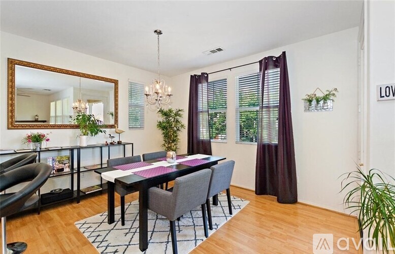 A dining room with a table and chairs.