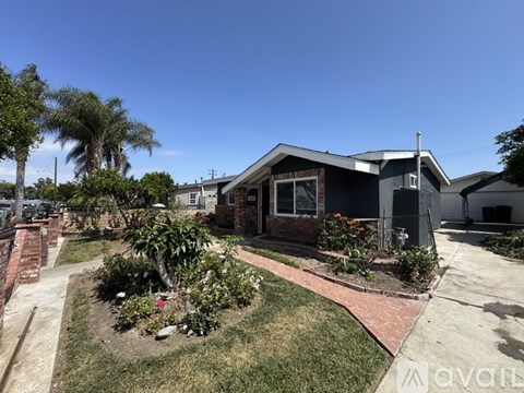 A house with a garden in front of it is for sale.