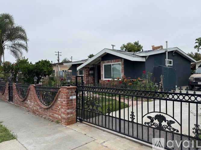 A black iron fence with a decorative design on it.