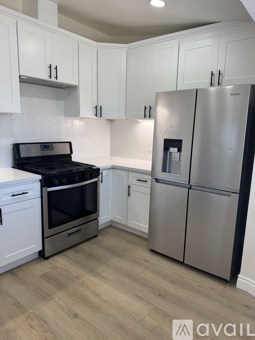 A kitchen with a stainless steel refrigerator and oven.
