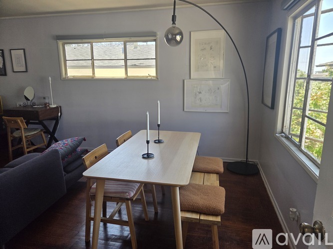A dining room with a wooden table and chairs.