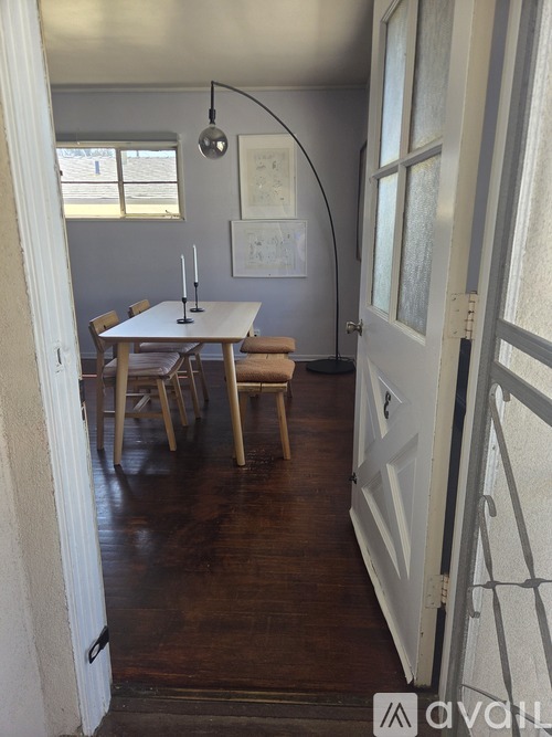 A dining room with a white table and chairs.