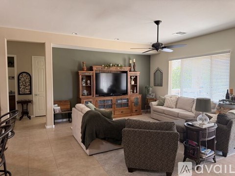 A living room with a television and a couch.