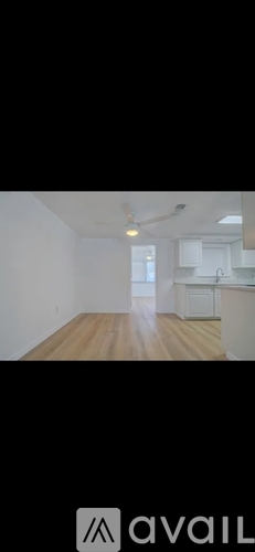 A room with wooden flooring and a ceiling fan.