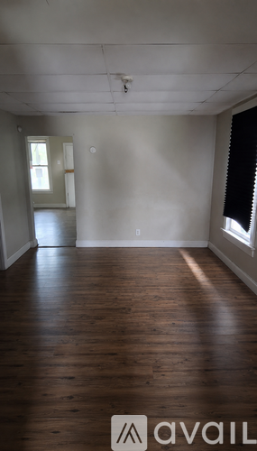A room with wooden floors and white walls.