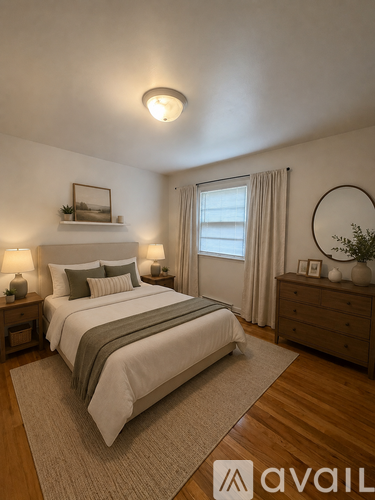 A bedroom with a large bed, nightstands, and a window with curtains.