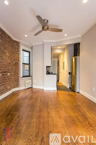 A room with wooden floors and a ceiling fan.