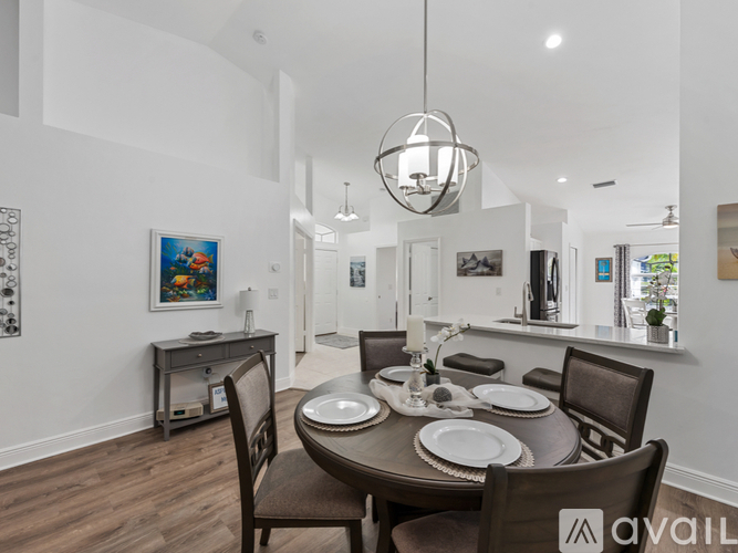 A modern dining room with a wooden table and chairs.