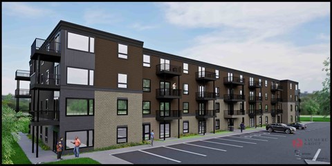 A modern apartment complex with a parking lot in front.