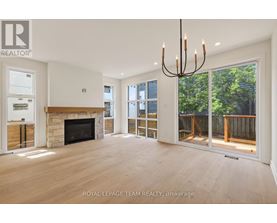 A spacious living room with a fireplace and sliding glass doors.