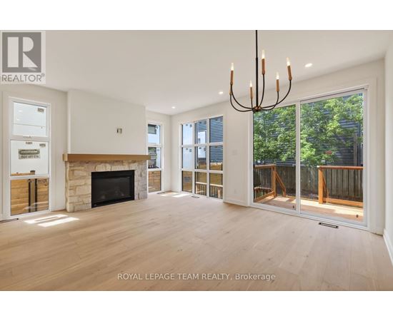 A spacious living room with a fireplace and sliding glass doors.