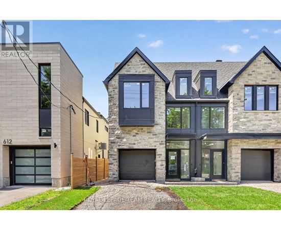 A modern house with a stone facade and a garage door.