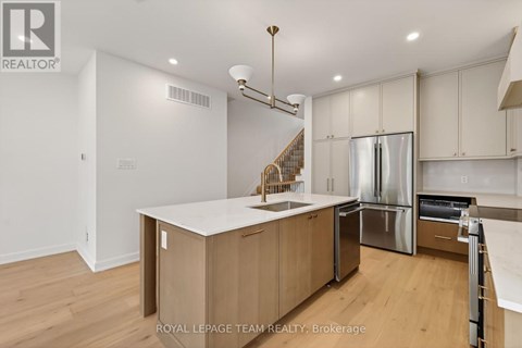 A modern kitchen with wooden cabinets and stainless steel appliances.