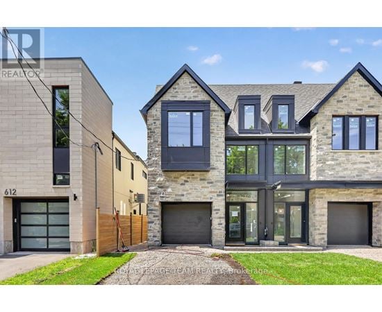 A modern house with a stone facade and a garage door.