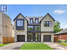 A modern house with a stone facade and large windows is for sale.